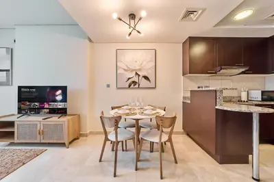 a kitchen and dining room with a table and chairs at Chic Studio in Sky Gardens, DIFC Prime Location in Dubai
