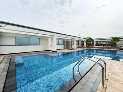 a swimming pool next to a building at Chic Studio in Sky Gardens, DIFC Prime Location in Dubai