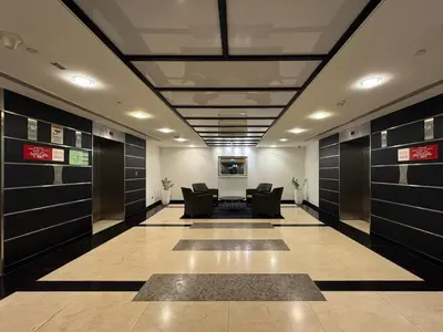 a hallway with chairs in a room with doors at Chic Studio in Sky Gardens, DIFC Prime Location in Dubai