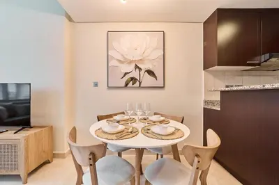 a dining room with a white table and chairs at Chic Studio in Sky Gardens, DIFC Prime Location in Dubai