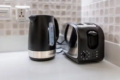 a toaster and toaster sitting on a kitchen counter at Palm Jumeirah Beachfront apartment with Amazing Infinity Pool and private beach in Dubai