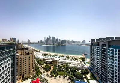 a view of the city from a building at Palm Jumeirah Beachfront apartment with Amazing Infinity Pool and private beach in Dubai
