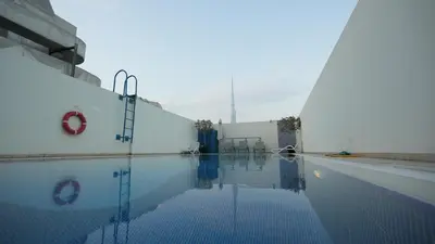a swimming pool in a building with the sky in the background at 1BHK full canal view apartment in Business bay ! in Dubai