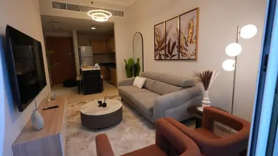 a living room with a couch and a table at 1BHK full canal view apartment in Business bay ! in Dubai