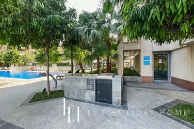 a resort with a swimming pool and a building at LUX The Burj Khalifa Fountain View Suite 2 in Dubai