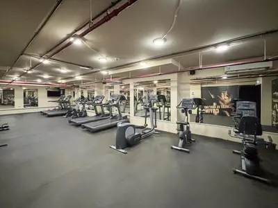 a gym with several treadmills and cardio machines at Frank Porter - Bay Square in Dubai