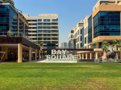 a building with a bay square sign in a city at Frank Porter - Bay Square in Dubai