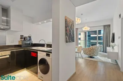 a kitchen with a washer and dryer in a room at Exquisite 1 Bedroom Sea View with Lavish Amenities in Dubai
