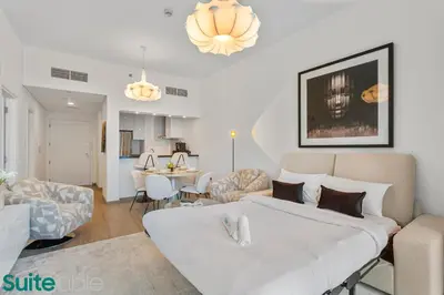 a bedroom with a large bed and a living room at Exquisite 1 Bedroom Sea View with Lavish Amenities in Dubai