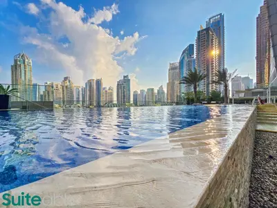 a swimming pool with a city skyline in the background at Exquisite 1 Bedroom Sea View with Lavish Amenities in Dubai