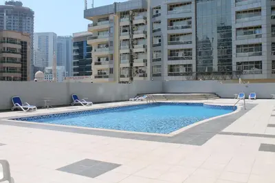 a swimming pool on the roof of a building at Cozy one bedroom close to beach and metro station in Dubai