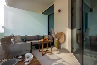 a living room with a couch and a table at Missoni Luxury Life Suite DPA Direct Pool Access in Dubai