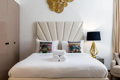 a bedroom with a large white bed with two towels at Missoni Luxury Life Suite DPA Direct Pool Access in Dubai