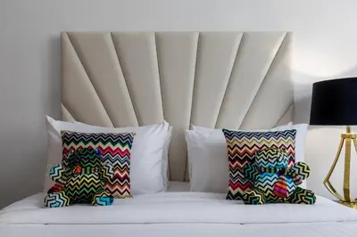 a bed with two pillows and a headboard at Missoni Luxury Life Suite DPA Direct Pool Access in Dubai