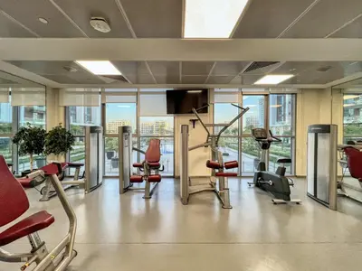 a gym with cardio equipment in a building at Sleek and Modern Stay in Dubai Hills in Dubai