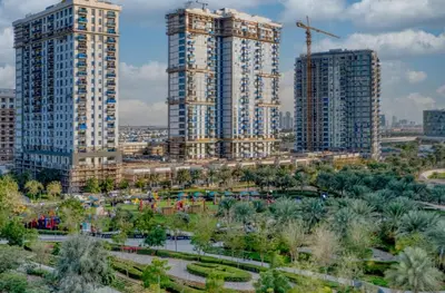 two tall buildings in a city with a park at Sleek and Modern Stay in Dubai Hills in Dubai