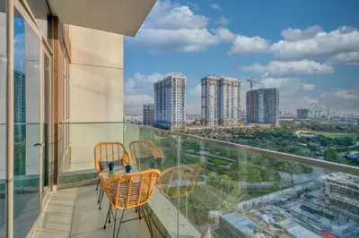 a balcony with chairs and a view of the city at Sleek and Modern Stay in Dubai Hills in Dubai