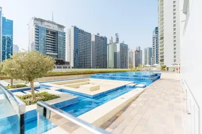 a pool in the middle of a city with tall buildings at City View 1BR Prime Location in Business Bay by Vibel in Dubai