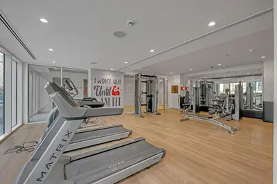 a gym with treadmills and machines in a room at City View 1BR Prime Location in Business Bay by Vibel in Dubai