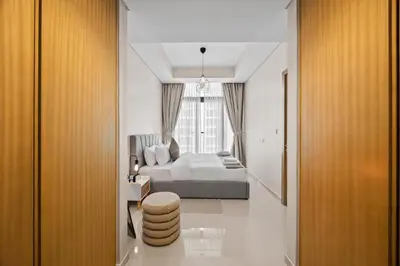 a bedroom with a bed and a large window at Dubai Aykon city in Dubai