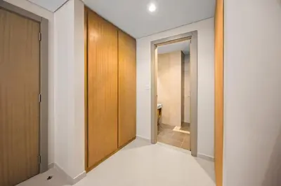 a hallway with wooden cabinets and a bathroom at Dubai Aykon city in Dubai