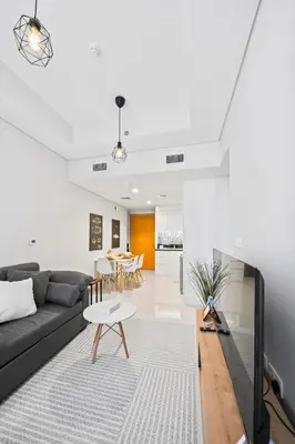 a living room with a couch and a table at Dubai Aykon city in Dubai