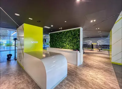 a lobby with a green wall in a building at Dubai Aykon city in Dubai