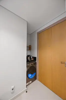 a laundry room with a washing machine and a door at Dubai Aykon city in Dubai