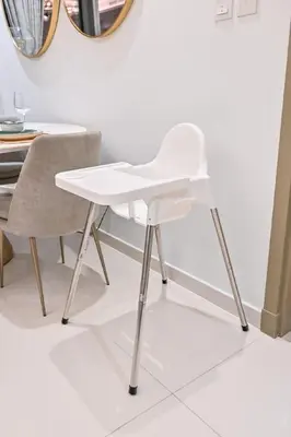a white chair sitting next to a table at New Luxury SeaView 2Bed - Spectacular Rooftop Infinity Pool, Bar & Burj Views! in Dubai