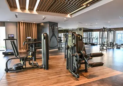 a gym with treadmills and exercise equipment in a building at New Luxury SeaView 2Bed - Spectacular Rooftop Infinity Pool, Bar & Burj Views! in Dubai