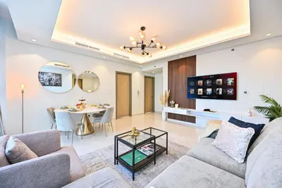 a living room with a couch and a table at New Luxury SeaView 2Bed - Spectacular Rooftop Infinity Pool, Bar & Burj Views! in Dubai