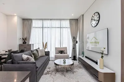 a living room with a couch and a table at High-Rise 1BR Apartment with Burj Khalifa view in Dubai