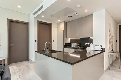 a kitchen with a sink and a counter top at High-Rise 1BR Apartment with Burj Khalifa view in Dubai