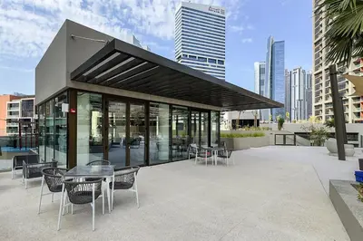a building with a table and chairs in a city at High-Rise 1BR Apartment with Burj Khalifa view in Dubai