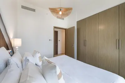 a bedroom with a large white bed with white pillows at ALiving Elite 3BR Apartment I Burj Khalifa & Fountain View I Burj Royale in Dubai