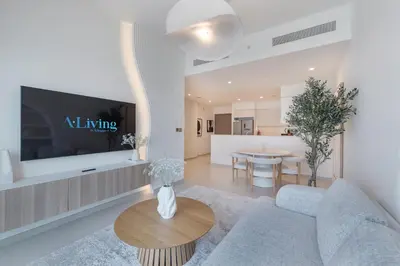 a living room with a couch and a table at ALiving Elite 3BR Apartment I Burj Khalifa & Fountain View I Burj Royale in Dubai