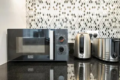 a microwave sitting on top of a kitchen counter at Stylish 2BR Apt in 5 Star Hotel with Burj Khalifa Views in Dubai
