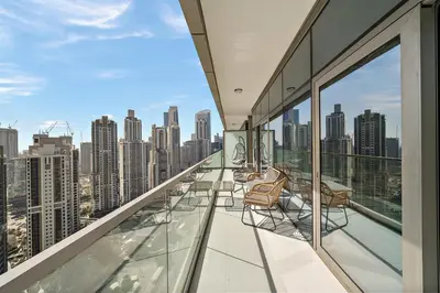 a balcony with chairs and a view of a city at Stylish 2BR Apt in 5 Star Hotel with Burj Khalifa Views in Dubai