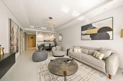 a living room with a couch and a table at Stylish 2BR Apt in 5 Star Hotel with Burj Khalifa Views in Dubai