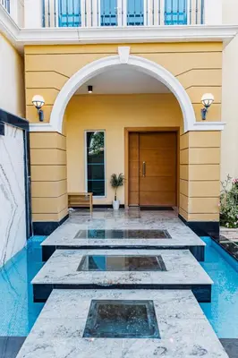 an entrance to a building with blue water at Stunning 4BR Jumeira Park Villa With Pool and Jacuzzi in Dubai