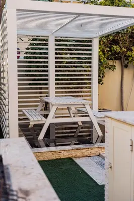 a picnic table sitting on top of a patio at Stunning 4BR Jumeira Park Villa With Pool and Jacuzzi in Dubai