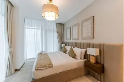 a bedroom with a large bed and a large window at FAM Living - 3 bedroom and Maids Room Retreat Overlooking Dubai Canal in Dubai