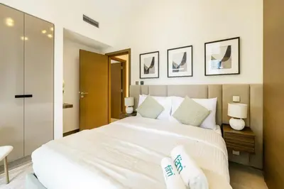 a bedroom with a large white bed with two pillows at FAM Living - 3 bedroom and Maids Room Retreat Overlooking Dubai Canal in Dubai