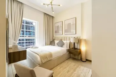 a bedroom with a white bed and a window at FAM Living - 3 bedroom and Maids Room Retreat Overlooking Dubai Canal in Dubai