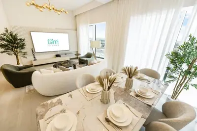 a living room with a couch and a table at FAM Living - 3 bedroom and Maids Room Retreat Overlooking Dubai Canal in Dubai