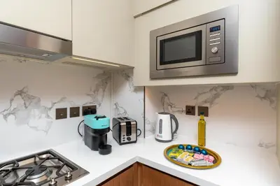 a kitchen with a microwave and a plate on a counter at Ultimate Stay Luxurious Address Opera 2BR Next to Burj Khalifa and Dubai Mall Large Balcony with Stunning Views in Dubai