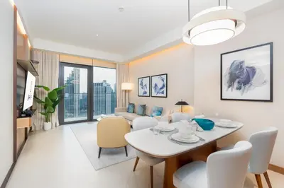 a dining room and living room with a table and chairs at Ultimate Stay Luxurious Address Opera 2BR Next to Burj Khalifa and Dubai Mall Large Balcony with Stunning Views in Dubai