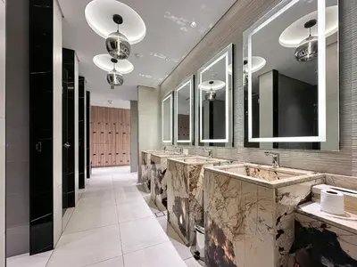 a bathroom with a row of sinks and mirrors at Trophy-Lux 1BR Jacuzzi Suite Busbay W Big Balcony in Dubai