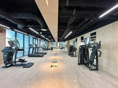 a gym with treadmills and ellipticals in a building at Trophy-Lux 1BR Jacuzzi Suite Busbay W Big Balcony in Dubai