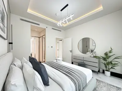 a white bedroom with a large bed and a mirror at Trophy-Lux 1BR Jacuzzi Suite Busbay W Big Balcony in Dubai